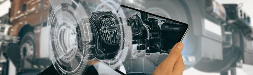 A tablet showing an exploded 3D view of a motor in front of industrial machinery