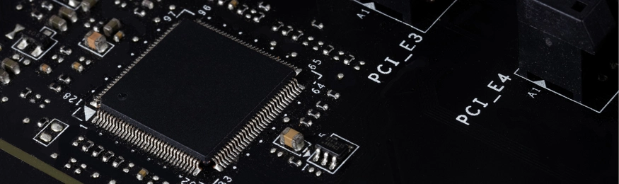 Close-up of a processor chip and PCI slots on a black circuit board