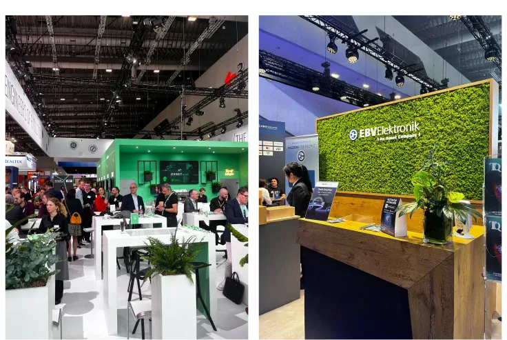 Busy exhibition hall with a green stand and visitors, next to the EBV Elektronik stand with a moss wall and counter