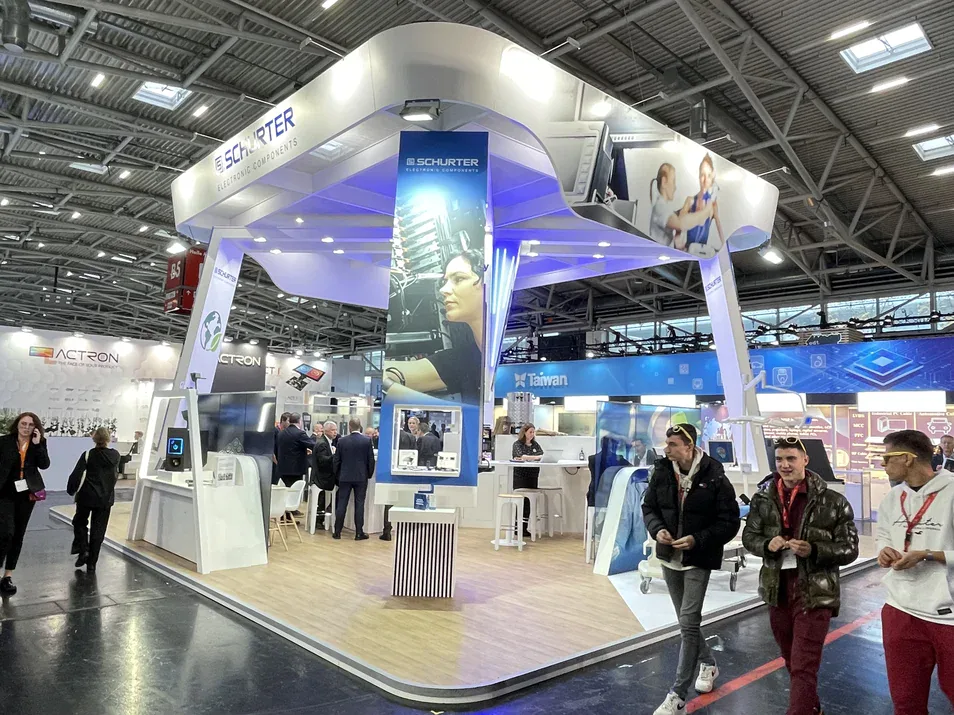 Schurter Electronic Components stand at electronica 2022 with visitors walking through the exhibition hall