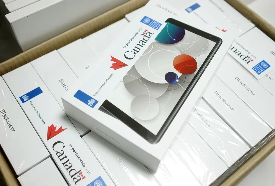 Carton of boxed Blackview tablets labelled "In partnership with Canada", Kingdom of the Netherlands and UNDP