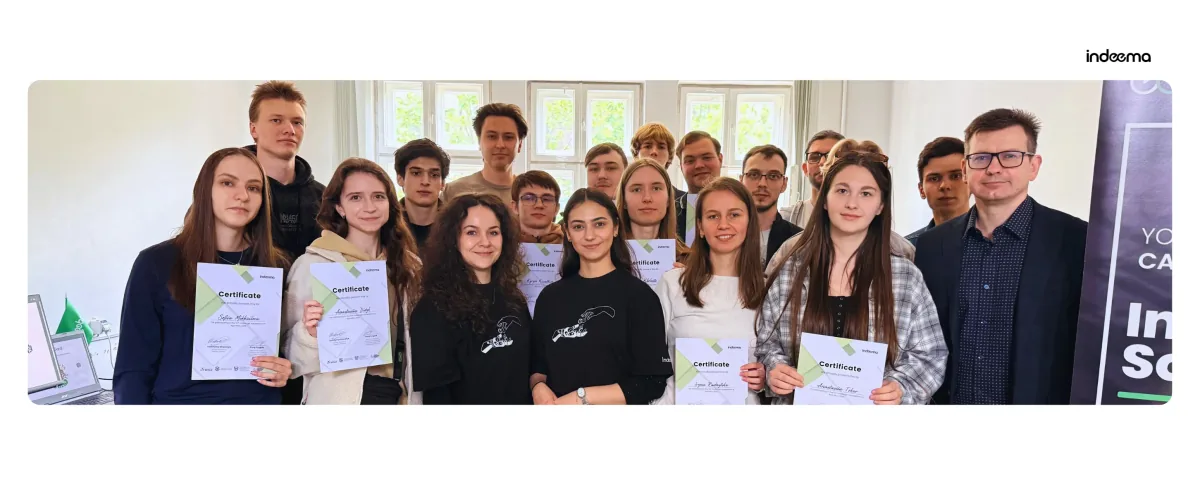 Group photo of IoT Challenge 2026 participants holding certificates, with a man in a blazer beside them